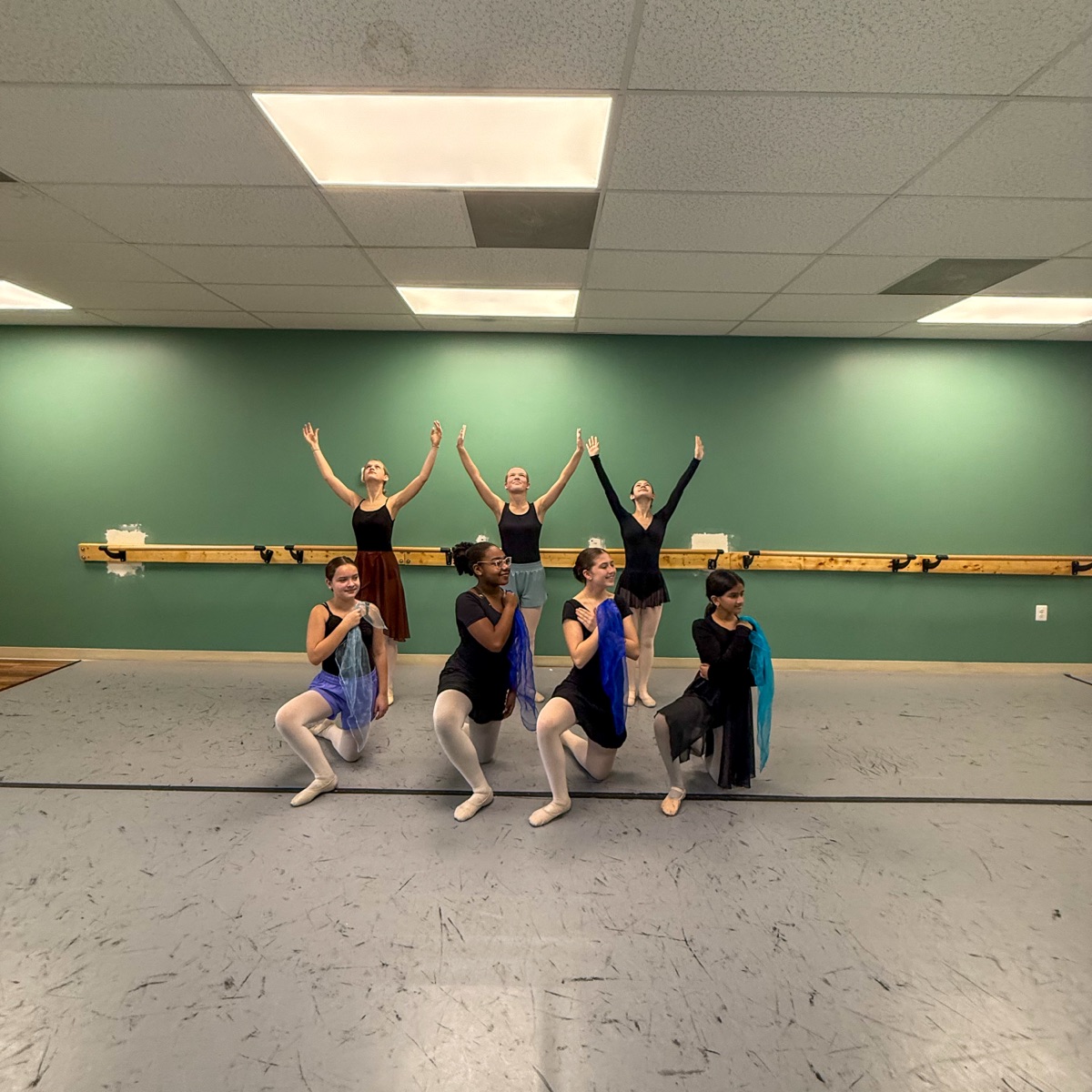 Dancers in worship pose with arms raised